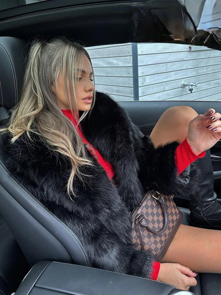 Fashionable woman in car wearing artificial fur cropped winter coat for stylish winter outfits