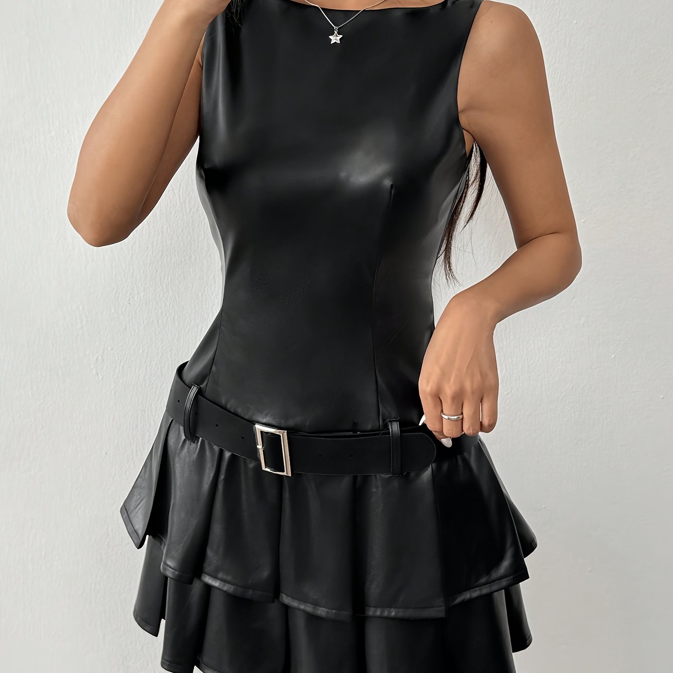Elegant Sleeveless Black PU Leather Pleated Dress with a stylish cinched waist and layered skirt