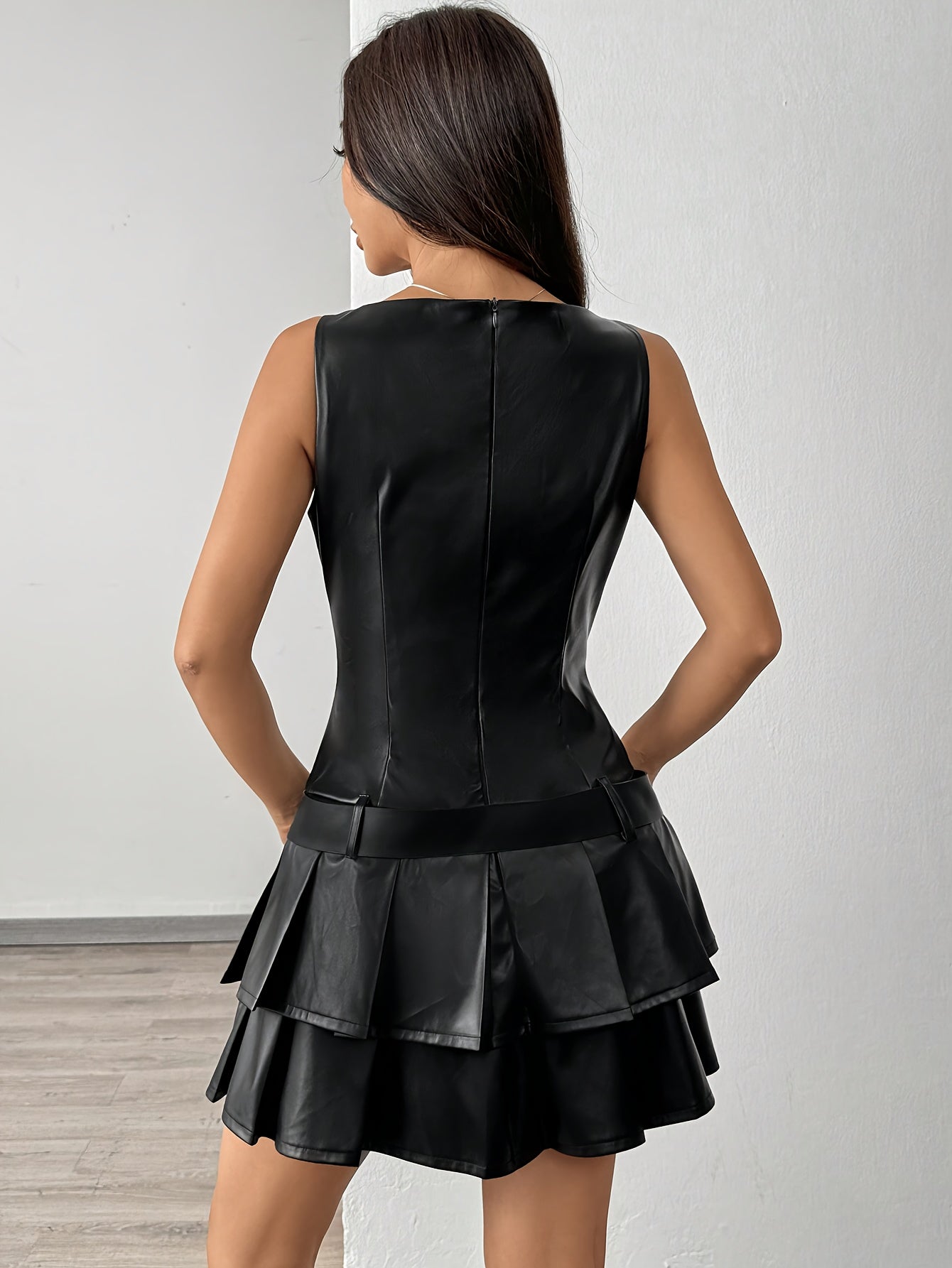 Elegant Sleeveless Black PU Leather Pleated Dress featuring a stylish pleated skirt and sleek design