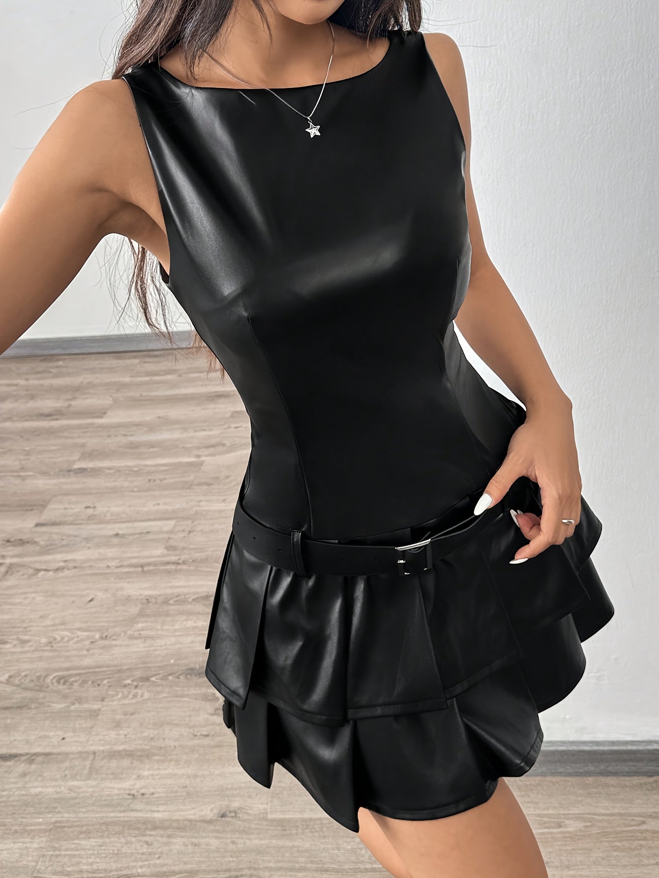 Elegant Sleeveless Black PU Leather Pleated Dress with a stylish ruffled hem and fitted silhouette