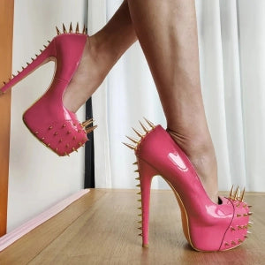 Pink high-heeled shoes with gold rivets, showcasing gold riveted platform pumps for a bold fashion statement