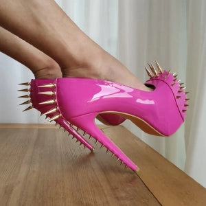 Pink high heel pumps with gold rivets, stylish and bold design for fashion-forward outfits