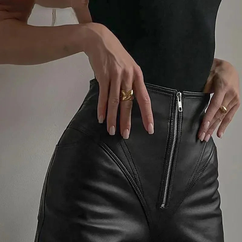 Close-up of high waist faux leather pants with stylish zipper detail for a chic look