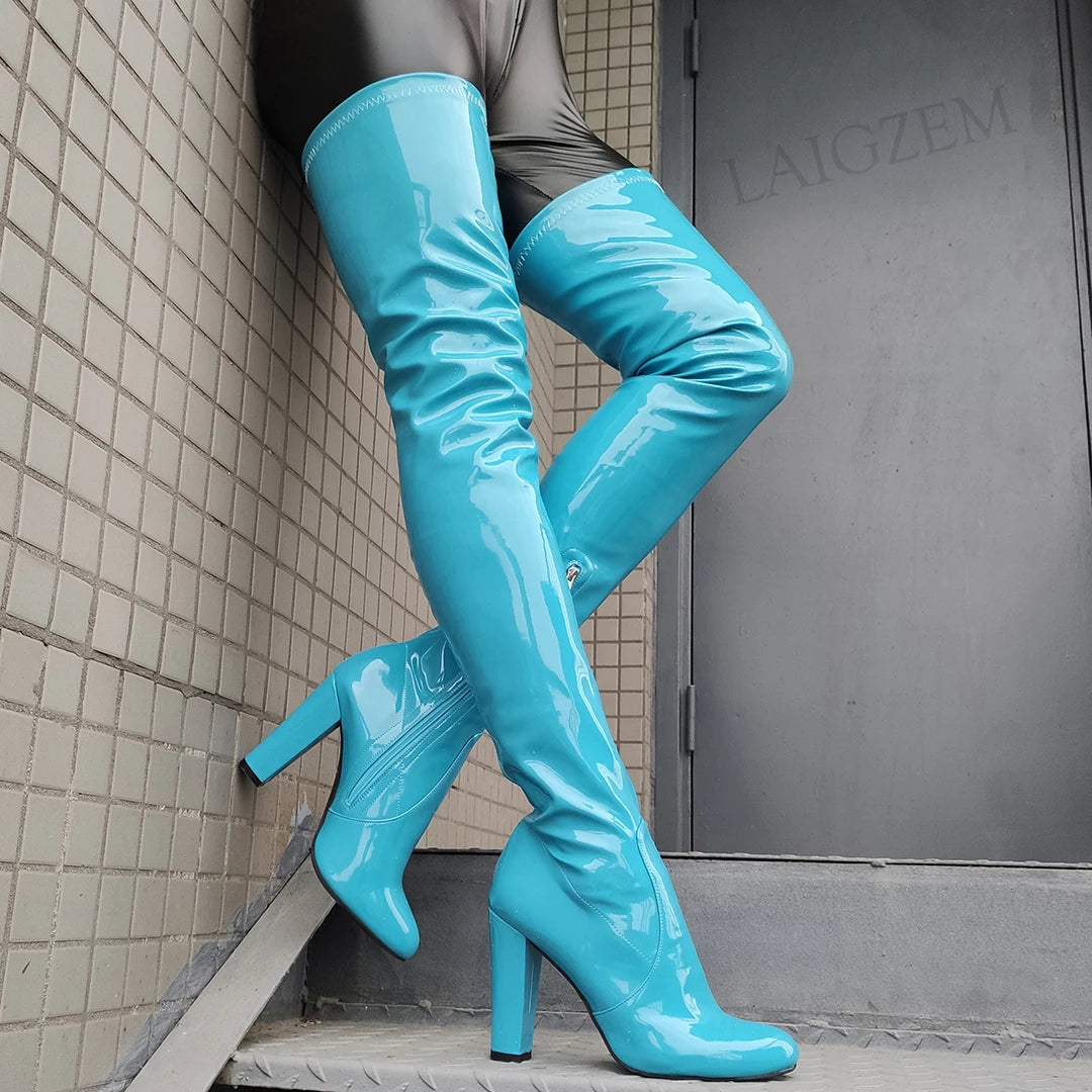 Shiny thigh high boots in turquoise with a sleek design for a bold fashion statement