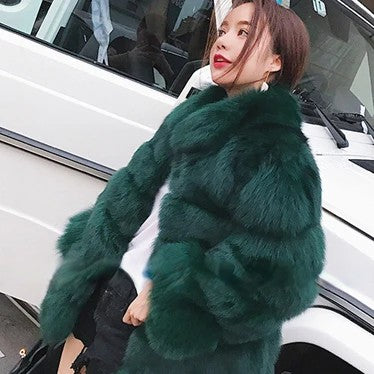 Stylish green luxury faux fur coat with statement sleeves for a chic winter look