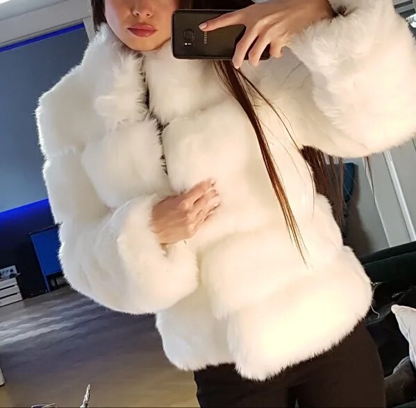White luxury faux fur coat with a modern design, perfect for stylish winter outfits