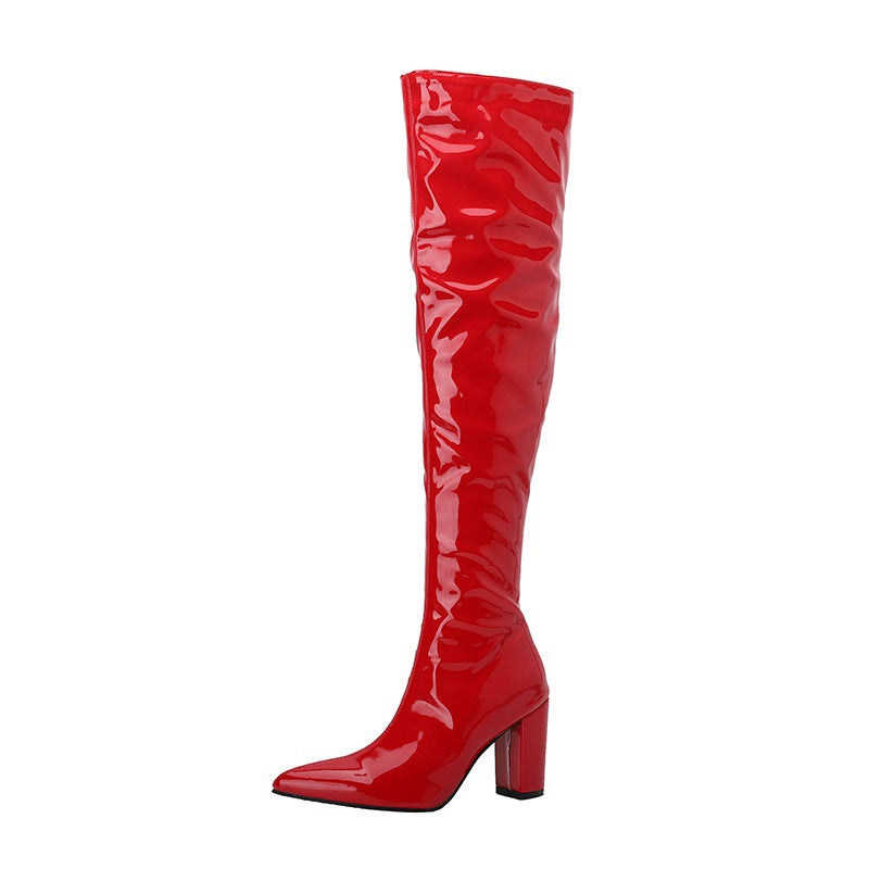 Bold red over the knee leather boots with a pointed toe and chunky heel for a stylish look