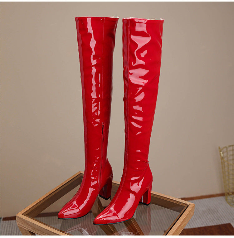 Stylish red over the knee leather boots with a pointed toe and block heel for a chic look