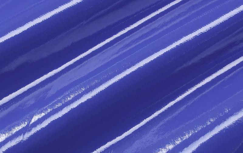 Close-up of blue faux leather cutout dress fabric showing glossy stripes for a stylish look