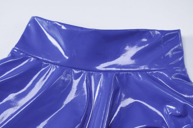Close-up of the waistband of a blue faux leather cutout dress by LEKINS highlighting its glossy finish