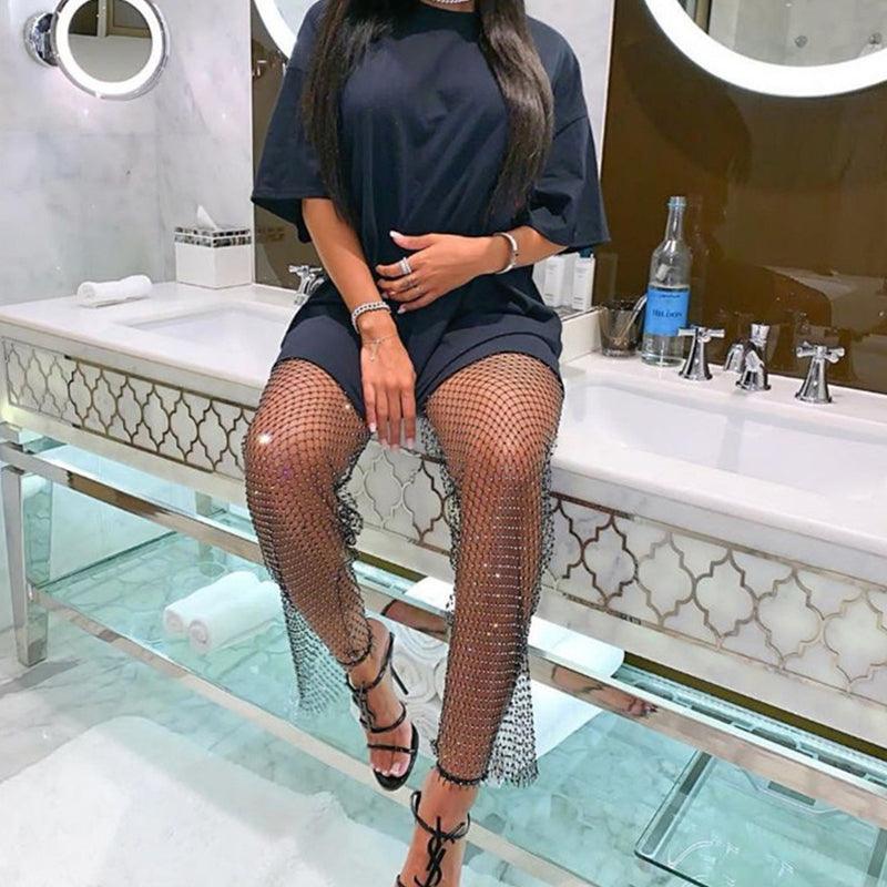 Dazzling Rhinestone Mesh Pants for Stylish Outfits paired with a chic top and high heels in a modern bathroom setting
