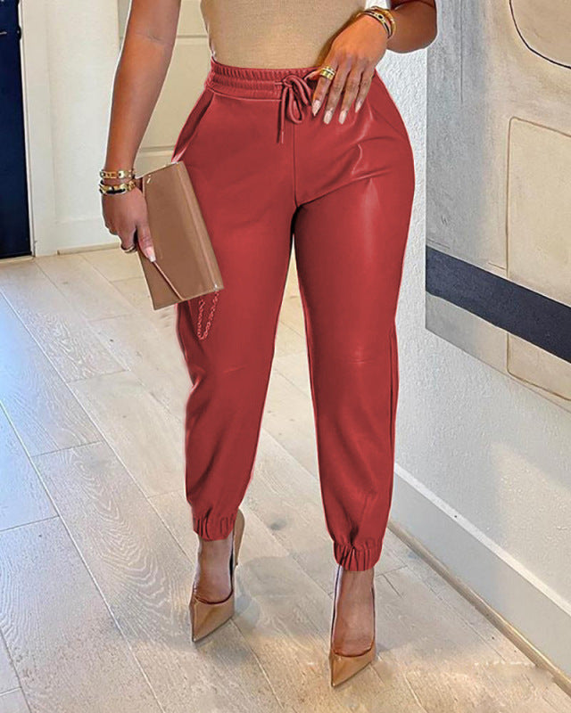 Stylish red drawstring faux leather trousers perfect for casual outings or chic events