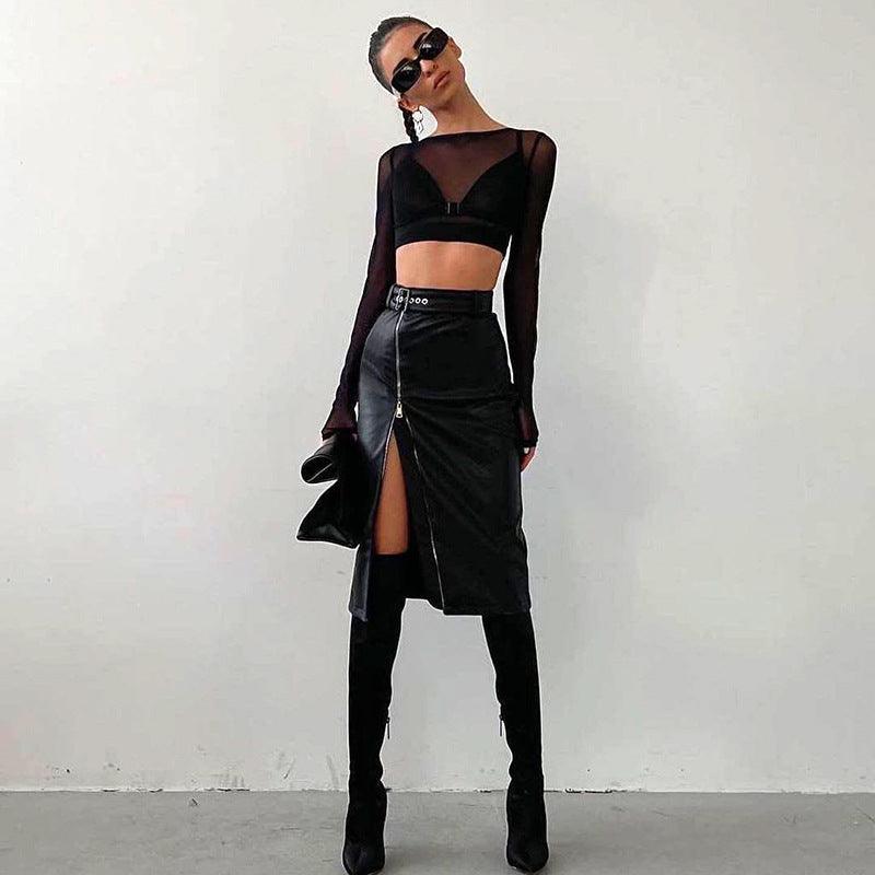 Fashion model wearing a high waist faux leather skirt with a front slit and stylish black top
