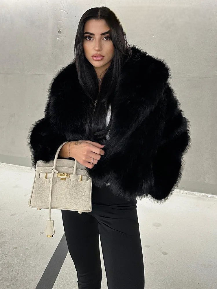 Stylish woman wearing an artificial fur cropped winter coat with a chic handbag