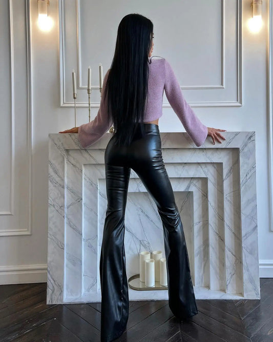Model wearing Flared High Waist PU Leather Trousers paired with a stylish sweater in a modern interior