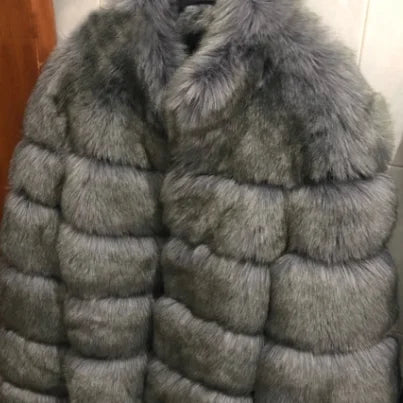 Luxury faux fur coat in gray with a puffy design, perfect for stylish and warm winter outfits